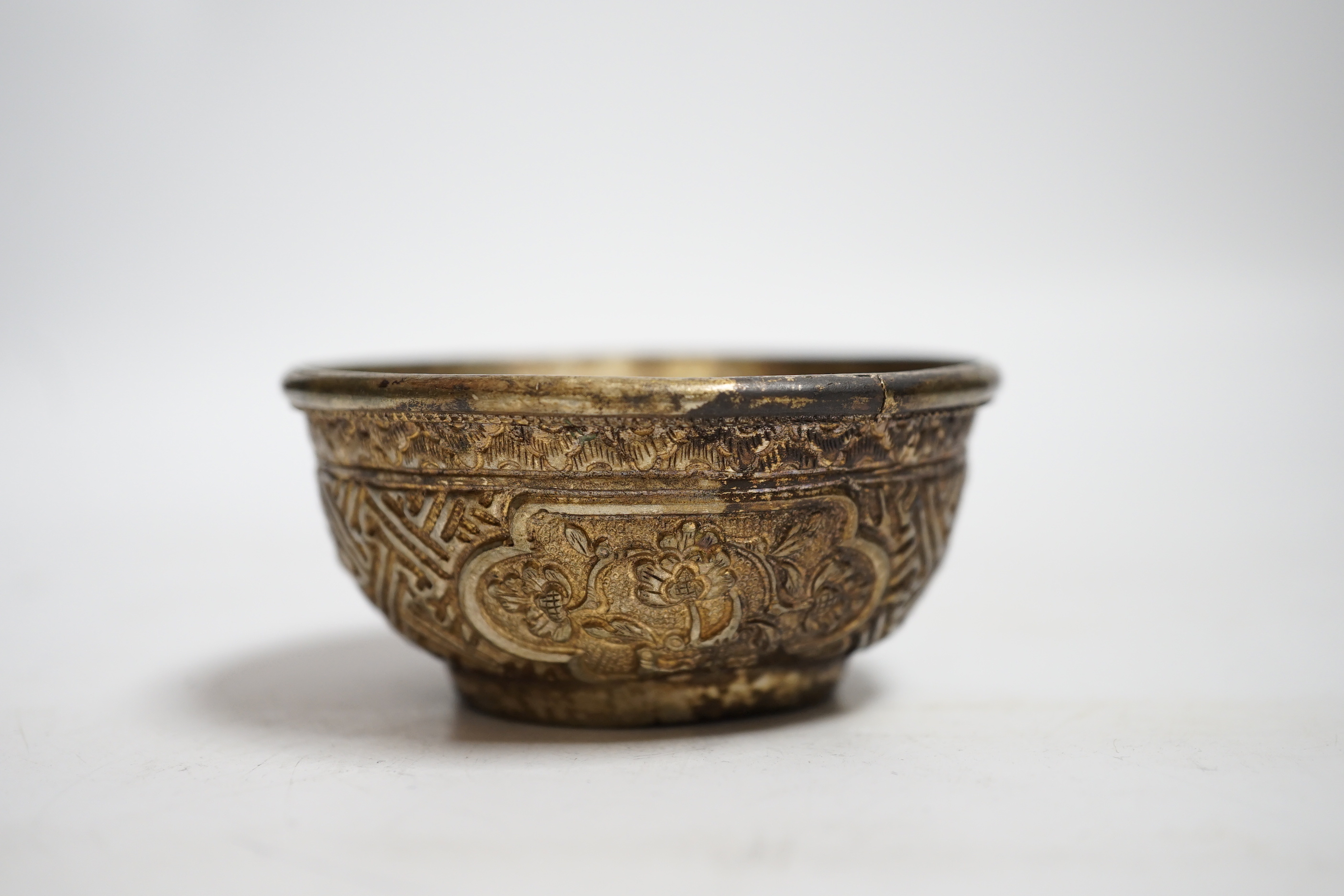 A Nepalese white metal tea bowl, 7.5cm diameter